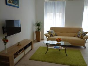 a living room with a couch and a coffee table at Apartments Vincent in Kastav