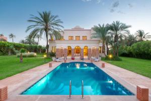 an exterior view of a house with a swimming pool at Domaine Rosaroum in Marrakech