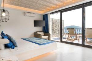 a bedroom with a bed and a balcony at Nur Beach Hotel in Kas