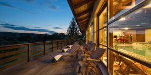 a row of chairs sitting on the balcony of a building at Wellness Hotel Happy Star in Hnanice