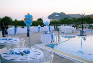 a group of tables with white chairs and balloons at Evgatis Hotel in Kondiás