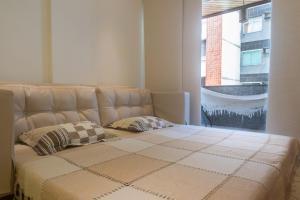 1 cama con 2 almohadas en una habitación en Apartamento de Luxo na Praia do Forte, en Cabo Frío