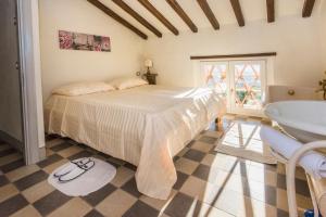 a bedroom with a bed and a tub and a sink at Valuable rustic Tuscan swimming pool, breathtaking view of Camaiore in Camaiore