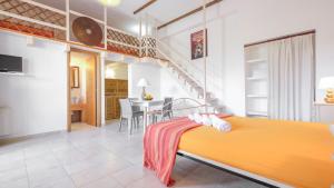 a bedroom with a bed and a dining room at Residence Contrada Schite in Presicce
