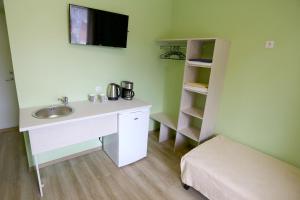 a bathroom with a desk and a sink and a shelf at Hostel Sport in Haapsalu