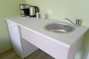 a white counter with a sink in a room at Hostel Sport in Haapsalu