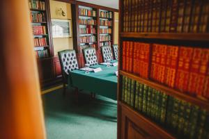 a room with a table and chairs in a library at Bushmills Inn Hotel & Restaurant in Bushmills