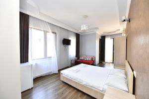 Postel nebo postele na pokoji v ubytování Hotel Phaliashvili