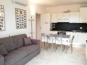 a living room with a couch and a table and chairs at Casa Bice Casa Vacanze in Case Pieve al Toppo