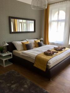 a large bed in a bedroom with a mirror at Beautiful Apartments in Prague in Prague