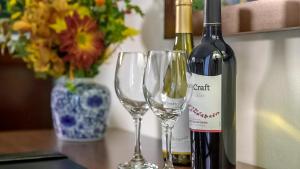 a bottle of wine and two wine glasses on a table at Inn at Pelican Bay in Naples