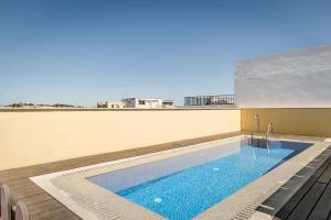 a swimming pool on the roof of a building at Eurostars Asta Regia Jerez in Jerez de la Frontera