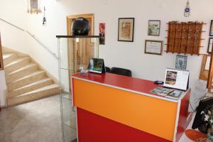 a red and orange counter in a room with stairs at Ozge Pansiyon in Didim