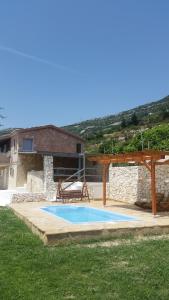 a swimming pool in a yard next to a building at House with pool Gabi in Kaštela