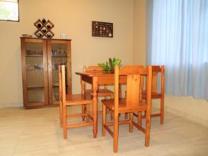 a dining room with a wooden table and chairs at 102 Siyayi in Mtunzini