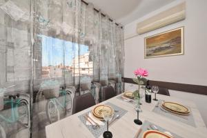 a dining room with a table and a window at Apartman Lana in city centre with garage in Zadar