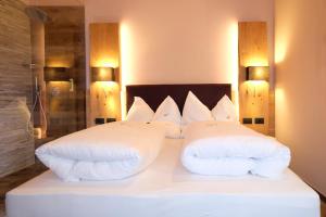 a bedroom with two white pillows on a bed at Vidor Resort in Pozza di Fassa