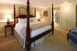 a bedroom with a large bed and a couch at Cape Arundel Inn and Resort in Kennebunkport