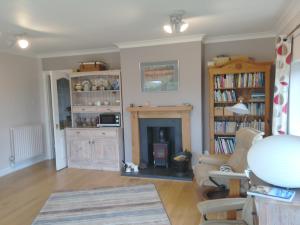 a living room with a couch and a fireplace at The Old Wash House in Fakenham