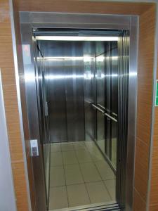 a elevator in a building with a glass door at MOne - fajny apartament w centrum Wrocławia in Wrocław