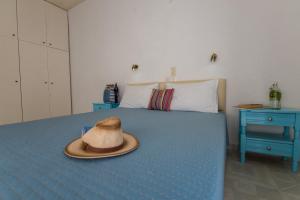a hat sitting on top of a bed at Vassilis Studios in Poros +23 photos
