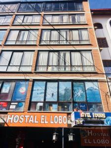 a building with a hospital el lobo sign in front of it at Lobo Hostel La Paz in La Paz