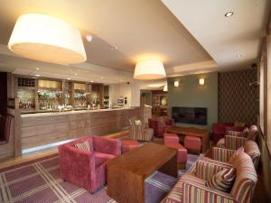a waiting room with chairs and a bar at Metropole Hotel and Spa in Llandrindod Wells