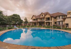 a large swimming pool in front of a house at The Cottage Guest House Gigiri in Nairobi