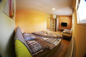 a room with two beds in a room at Apartmány Dimitra in Štúrovo