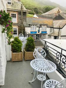 a balcony with two chairs and a table on a balcony at The Slipway in Port Isaac