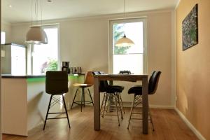a kitchen with a table and chairs in a room at YourHomeWismar in Wismar +8 photos
