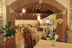a restaurant with tables and chairs with flowers on them at Ai Pigni De Cerù in Fumane