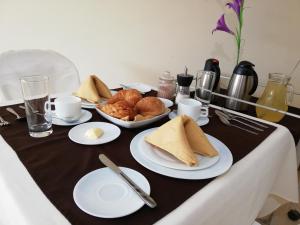 a table with plates of food on a table at Victoria Suites Hotel in Santo Domingo de los Colorados