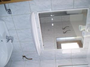a bathroom with a hole in the floor of a toilet at Apartments Medulin in Medulin