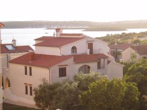 a large white house with a red roof at Apartments Medulin in Medulin