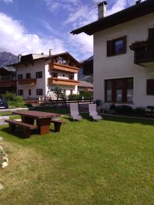 a patio with a table and chairs in front of a house at Casa dello Sciatore in Bormio