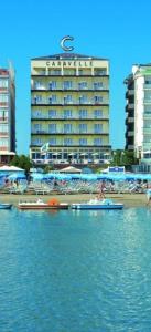 two boats in the water in front of a hotel at Hotel Caravelle in Cattolica