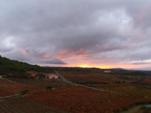 a sunset in a field with a dirt road at Carpe Diem in Navaridas