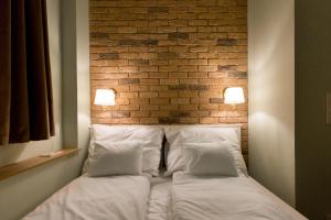 Posteľ alebo postele v izbe v ubytovaní Roland Apartments