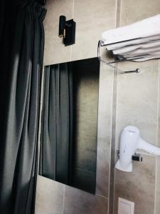 a bathroom with a shower with a black curtain at Memel home old city apartment in Klaipėda +13 photos