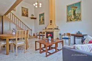 a living room with a table and a fireplace at Potideon Villa in Karpathos