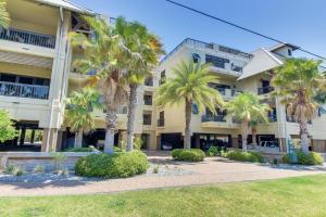 a building with palm trees in front of it at The Club at Mexico Beach in Mexico Beach