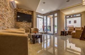 a living room with couches and a brick wall at Al Mare apartments Budva in Budva