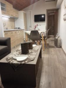 a kitchen and living room with a table and chairs at Koala Apartments- Irida, Elea Ierissos in Ierissos