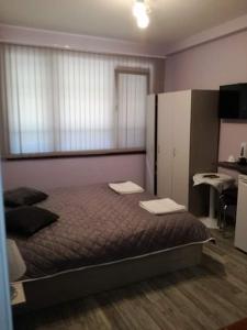 a bedroom with a bed with two desks on it at Saraya in Varna City