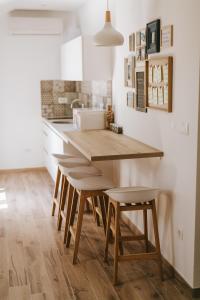 a kitchen with a wooden table and stools at Fyaka Loft Apartments in Vodice