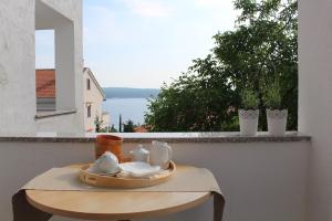 a tray of food on a table on a balcony at Mia 6 in Crikvenica +13 photos
