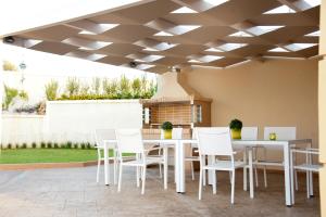 a patio with a white table and chairs under a ceiling at Villa Ariella in Agia Marina Nea Kydonias