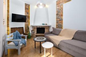 a living room with a couch and a fireplace at Lindos Diamond Exclusive Villa in Líndos