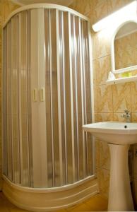 a shower in a bathroom with a sink at Hotel Est in Bucharest